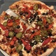 Thin Crust Pizza with Meat and Vegetables